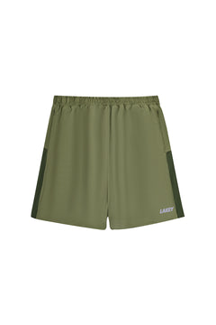 Green athletic shorts with a brand logo on a white background